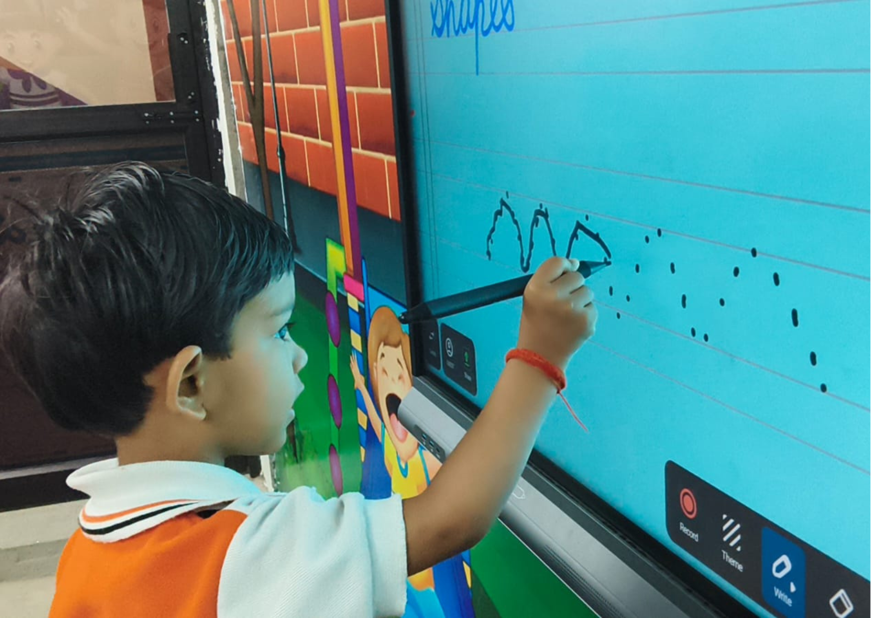 Seemant public school's student writing on smart board