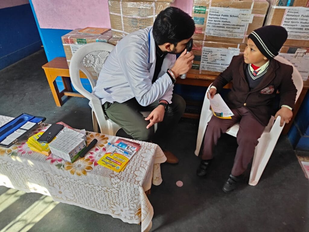 Doctor explaining eye health condition to patient during Seemant eye camp