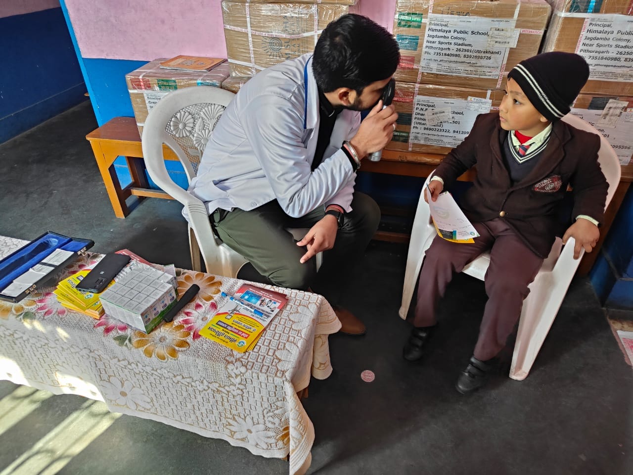 Doctor explaining eye health condition to patient during Seemant eye camp
