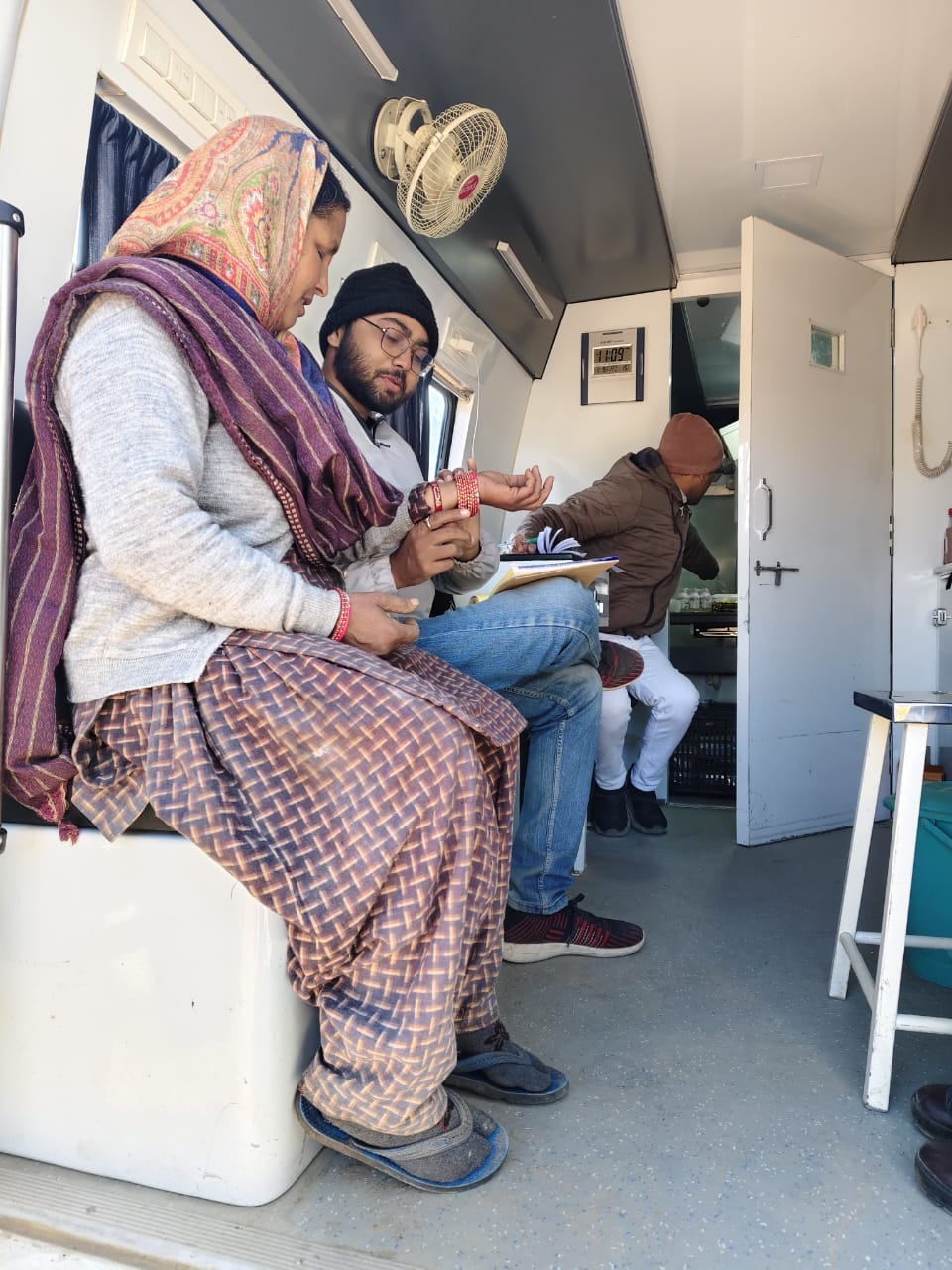 Woman receiving medical checkup inside Seemant Sewa Foundation mobile medical unit in Uttarakhand village