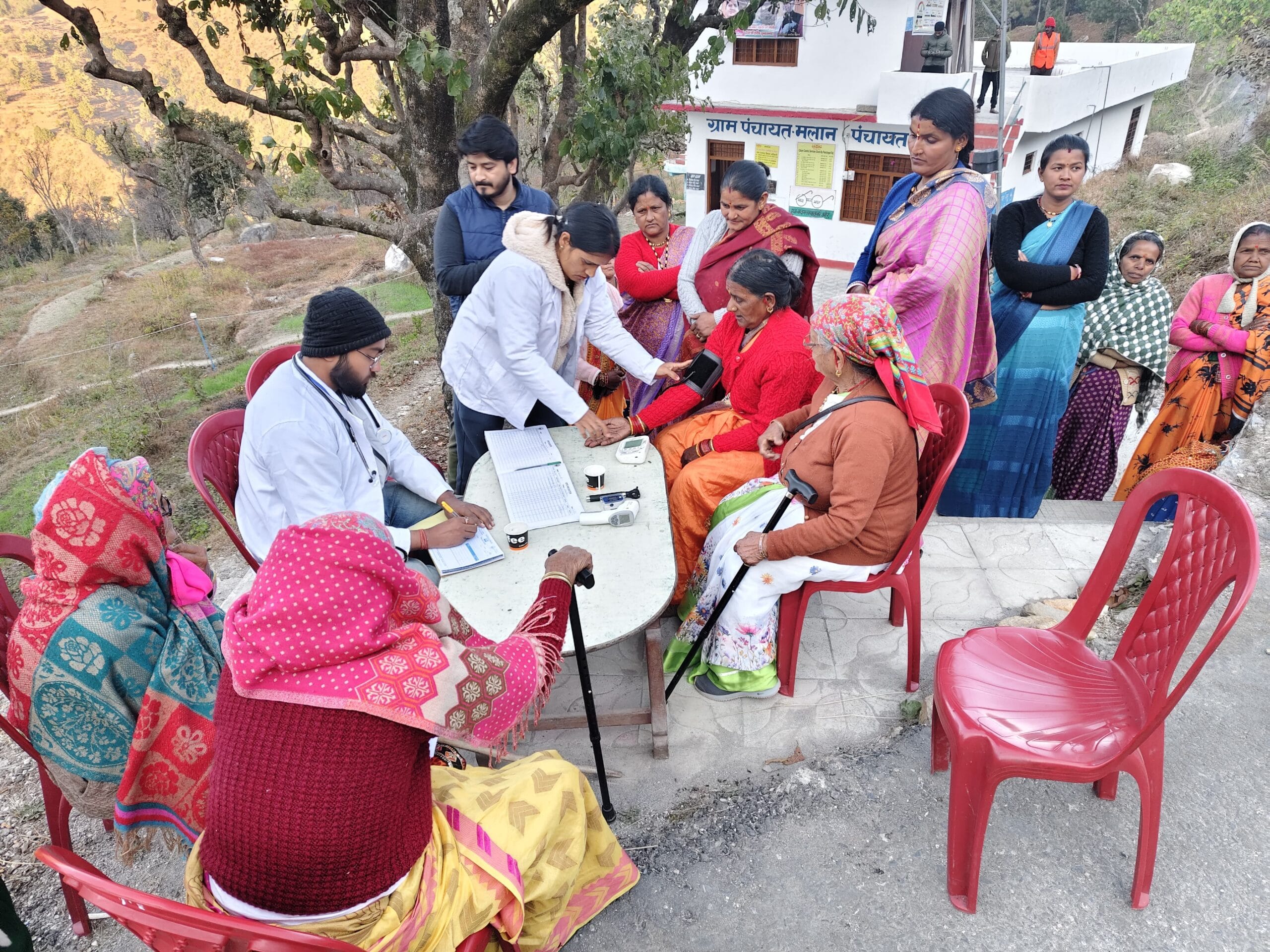 Mobile medical unit team serving villagers with healthcare and medicine distribution in Uttarakhand
