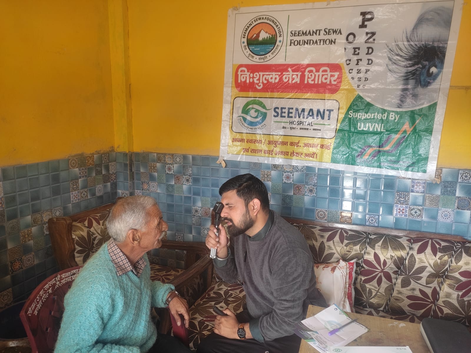 Elderly patient receiving free eyeglasses during Seemant eye camp