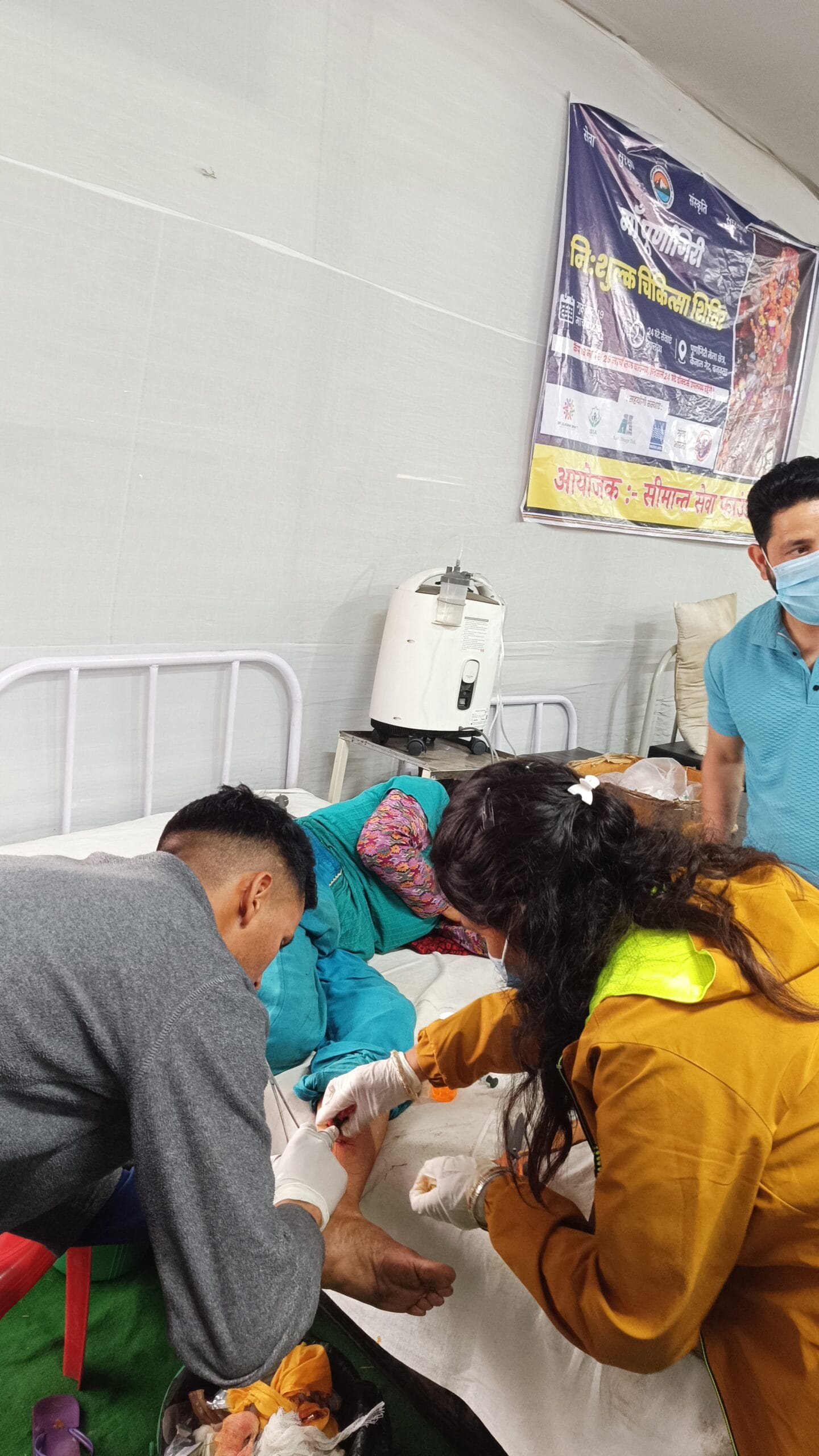 Doctors providing wound dressing services during Maa Purnagiri Medical Camp in Uttarakhand