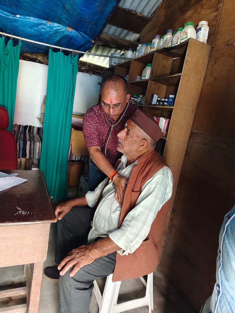 Col Dr Santosh Kumar Mishra examining a woman patient during rural healthcare camp in Uttarakhand